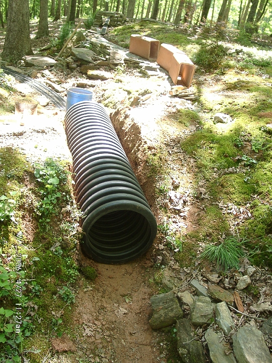 200604271127.JPG - The new tunnel liner is dropped into the excavation.  This is 12 inch drainage pipe.